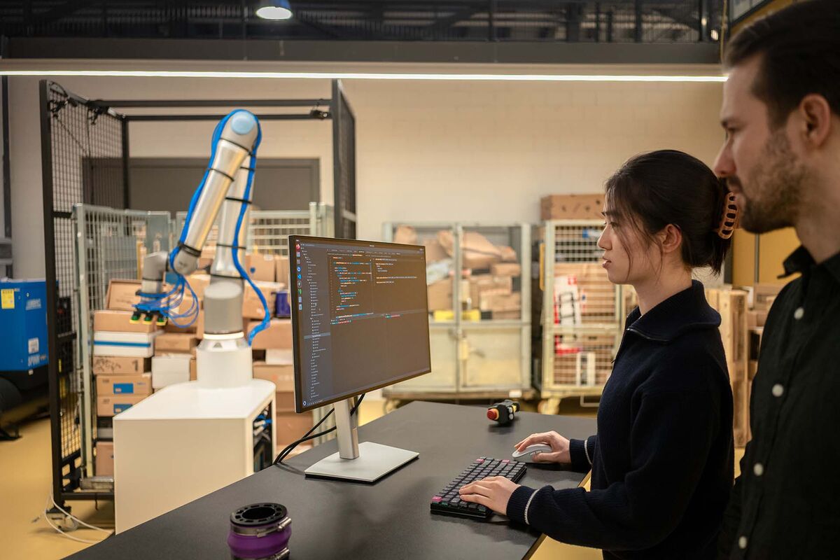 Two people working at a lab computer